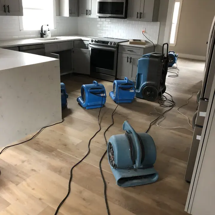 Air movers drying a Central Texas kitchen after water damage