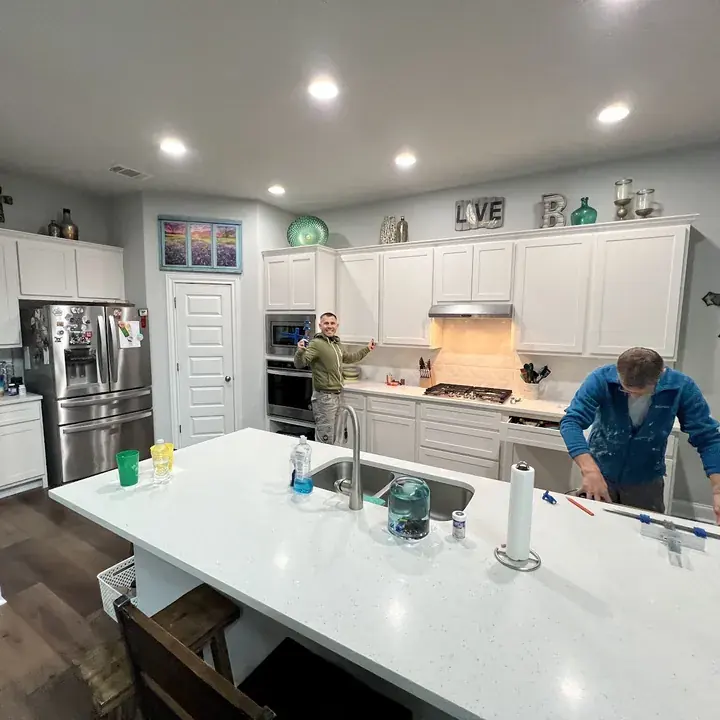 Crew restoring a kitchen after a supply-line leak